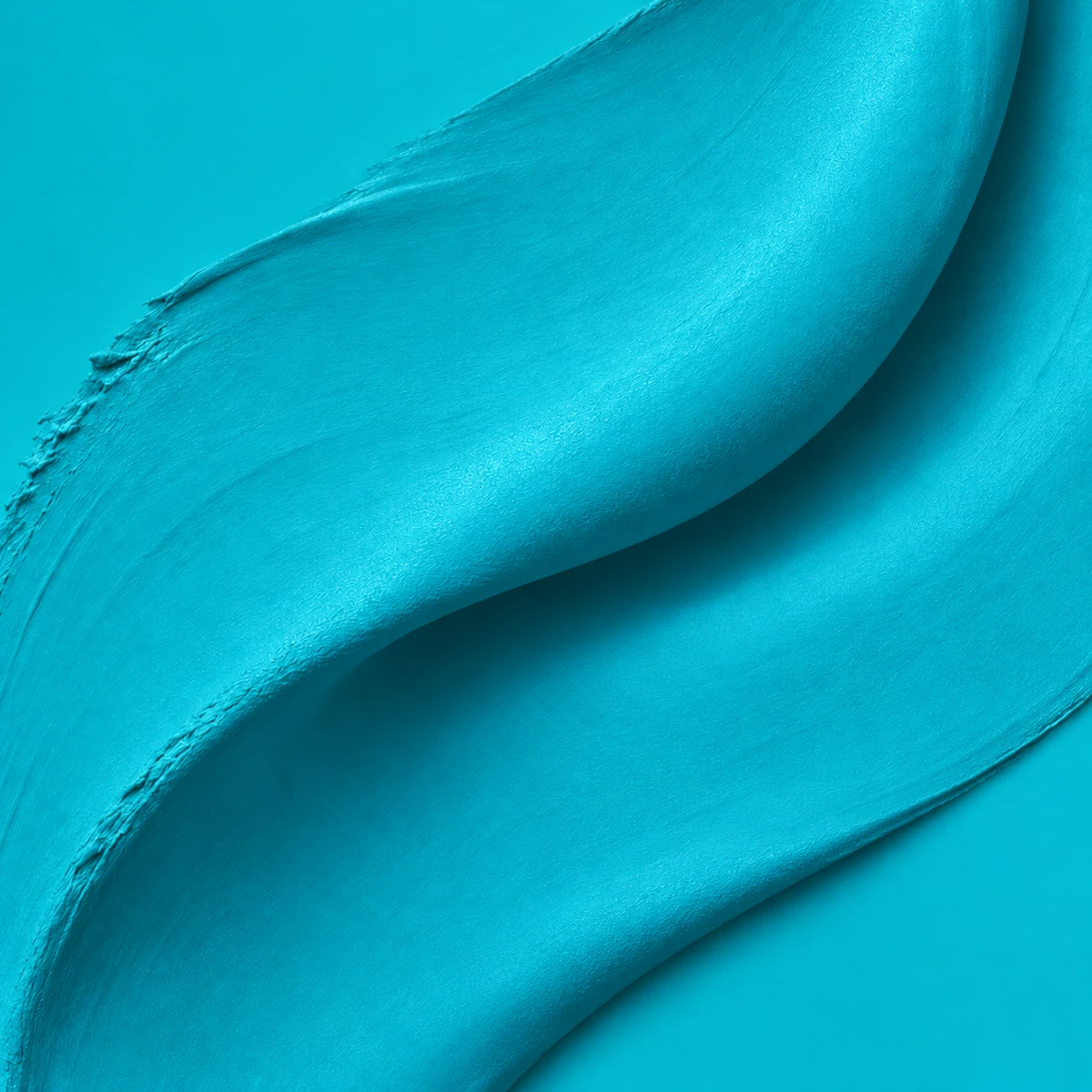 A sculptural sweep of saturated turquoise paint, folding in soft light.